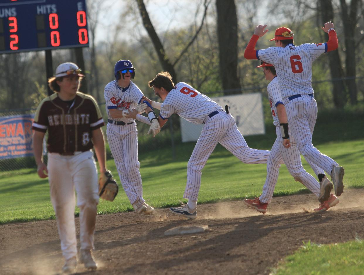Licking Valley's Brody Rodgers, center, celebrates his game-winning hit with Zane Hancock (9) to beat visiting Licking Heights 4-3 on Friday, April 19, 2024.