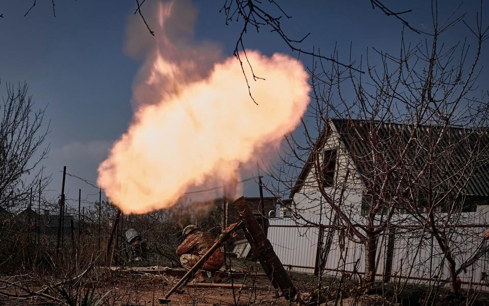 Ukrainian soldiers fire a mortar at Russian positions on the frontline near Bakhmut - Libkos/AP