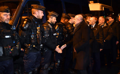 French Interior Minister Gerard Collomb (C) meets with gendarmes on February 2, 2018 in Calais, northern France - Credit:  PHILIPPE HUGUEN/AFP
