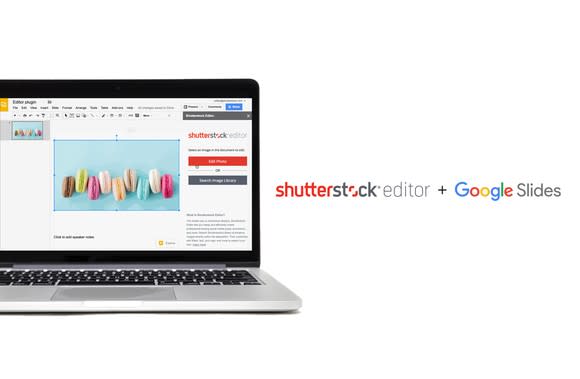 Silver laptop computer with Shutterstock editor program on display.