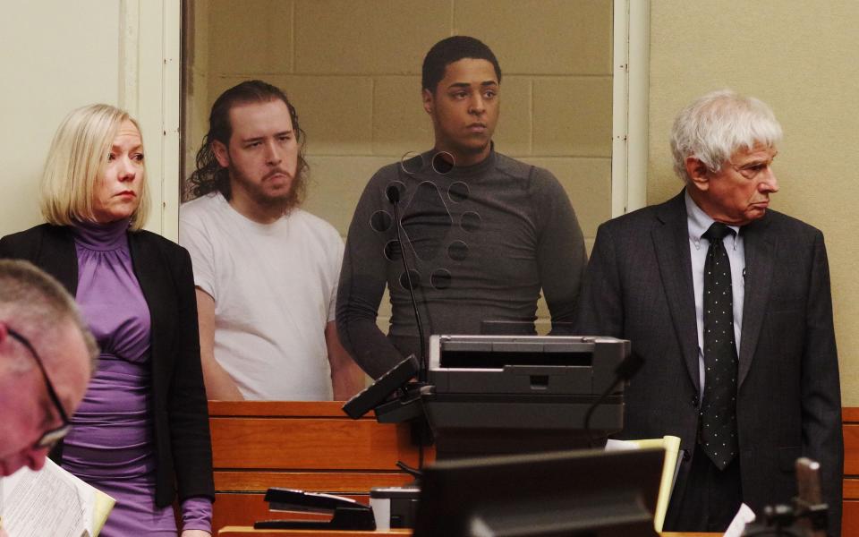 Antonio Dejesus, 26, of Taunton, and Sirick Amado, 24, of Brockton are arraigned Monday, April 1, 2024, in Brockton District Court on charges of accessory to murder in the fatal shooting of Sedrick Abreu on Sunday, March 31, 2024, in Brockton. On the far left is defense attorney Lauren Baker for Dejesus, and on the far right is defense attorney Elliot Levine for Amado, who is the victim's brother. Police are searching for a third brother, who is charged with murder in the shooting.
