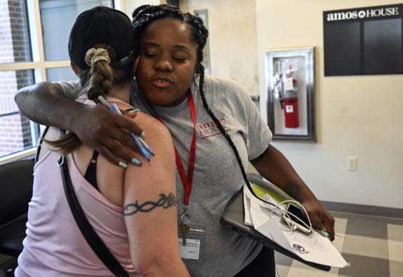 Partaja Spann-Taylor hugs a client at Amos House. Getting homeless, drug-addicted women off the streets inspired her to pursue a master’s in social work