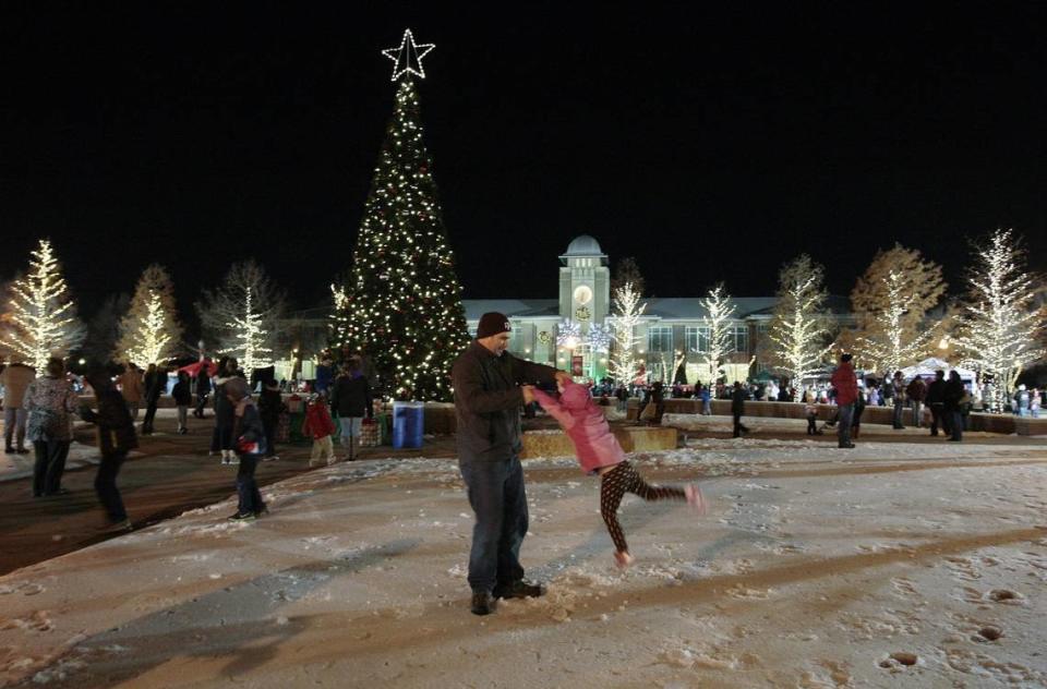 Zack Smith of Keller twirls his daughter, Carline, 4, on the ice around the Christmas tree moments after it was illuminated during Keller Holly Days on Tuesday, Dec. 10, 2013. The event had been rescheduled because of weather.