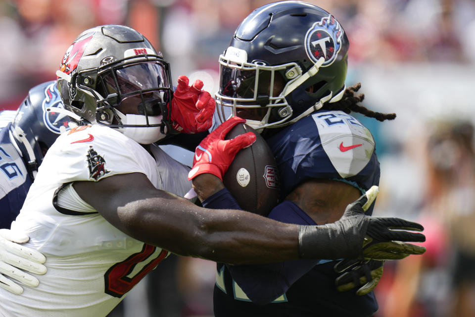 Tampa Bay Buccaneers linebacker Yaya Diaby, left, tackles Tennessee Titans running back Derrick Henry, right, during the first half of an NFL football game Sunday, Nov. 12, 2023, in Tampa, Fla. (AP Photo/Chris O'Meara)