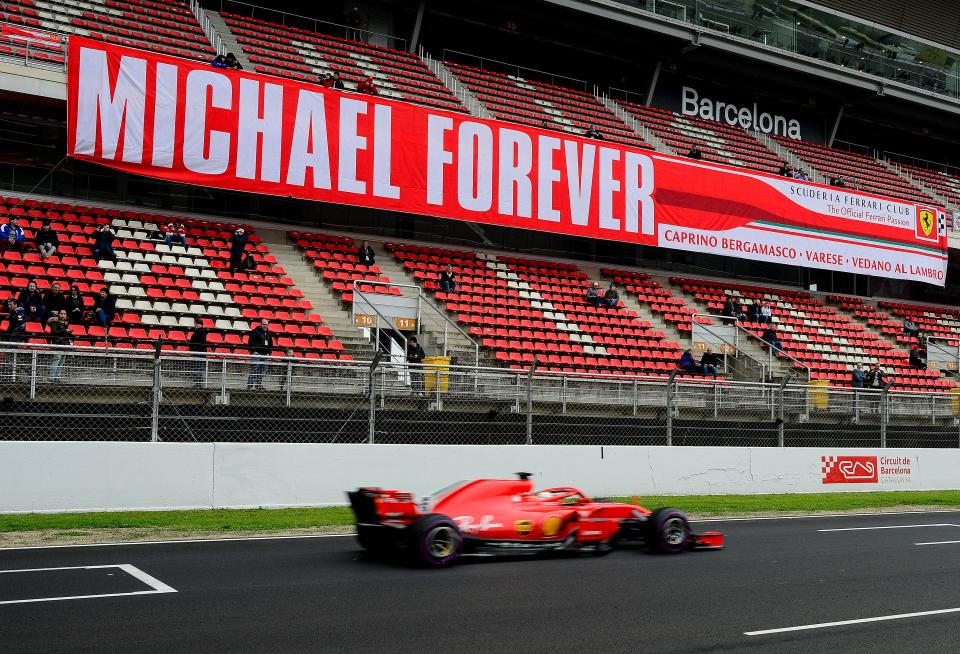 Ferrari's German driver Sebastian Vettel drives past a tribute-banner to former German driver Michael Schumacher drives at the Circuit de Catalunya on March 8, 2018 in Montmelo on the outskirts of Barcelona during the third day of the second week of tests for the Formula One Grand Prix season. / AFP PHOTO / Josep LAGO        (Photo credit should read JOSEP LAGO/AFP/Getty Images)