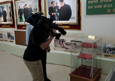 A television news cameraman films a chair once used by North Korean leader Kim Jong Un and now preserved at an exhibition at a cosmetics factory in Pyongyang, North Korea, September 8, 2018. Picture taken September 8, 2018. REUTERS/Josh Smith