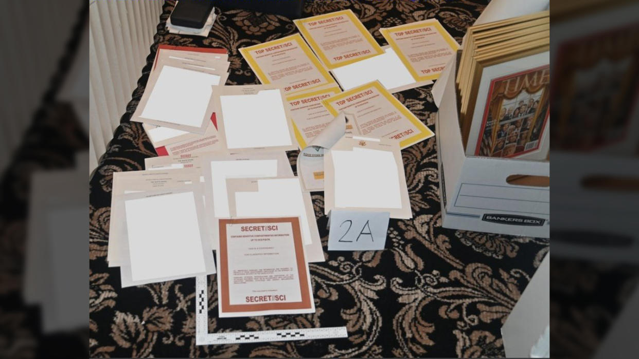 A photo of documents scattered on the floor.