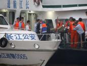 Rescue workers carry a body which was taken from the sunken ship in the Jianli section of Yangtze River, Hubei province, China, June 2, 2015. REUTERS/Kim Kyung-Hoon