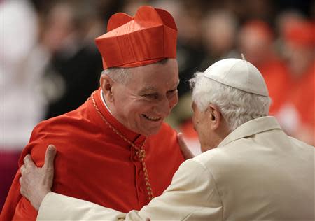 Former Pope Benedict embraces newly elected cardinal Pietro Parolin of Italy during a consistory ceremony led by Pope Francis in Saint Peter's Basilica at the Vatican February 22, 2014. REUTERS/Max Rossi