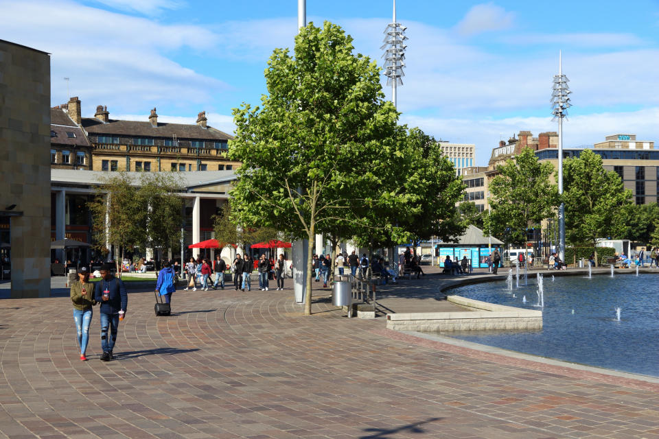 first-time buyer People visit Centenary Square in Bradford, UK. Bradford is one of largest cities in Yorkshire with population of 528,155.