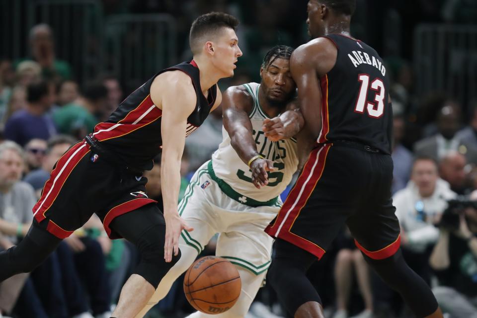 Miami Heat's Bam Adebayo (13) screens Boston Celtics' Marcus Smart (36) as Tyler Herro, left, drives during the second half of Game 3 of the NBA basketball Eastern Conference finals playoff series, Saturday, May 21, 2022, in Boston. (AP Photo/Michael Dwyer)