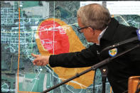 Ohio Governor Mike DeWine points to a map of East Palestine, Ohio that indicates the area that has been evacuated as a result of Norfolk Southern train derailment, after touring the site, Monday, Feb. 6, 2023, in East Palestine, Ohio. (AP Photo/Gene J. Puskar)