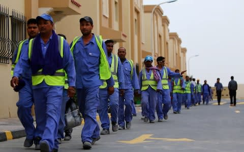 Foreign workers on the construction site of the al-Wakrah football stadium, one of the Qatar's 2022 World Cup stadiums - Credit: AFP