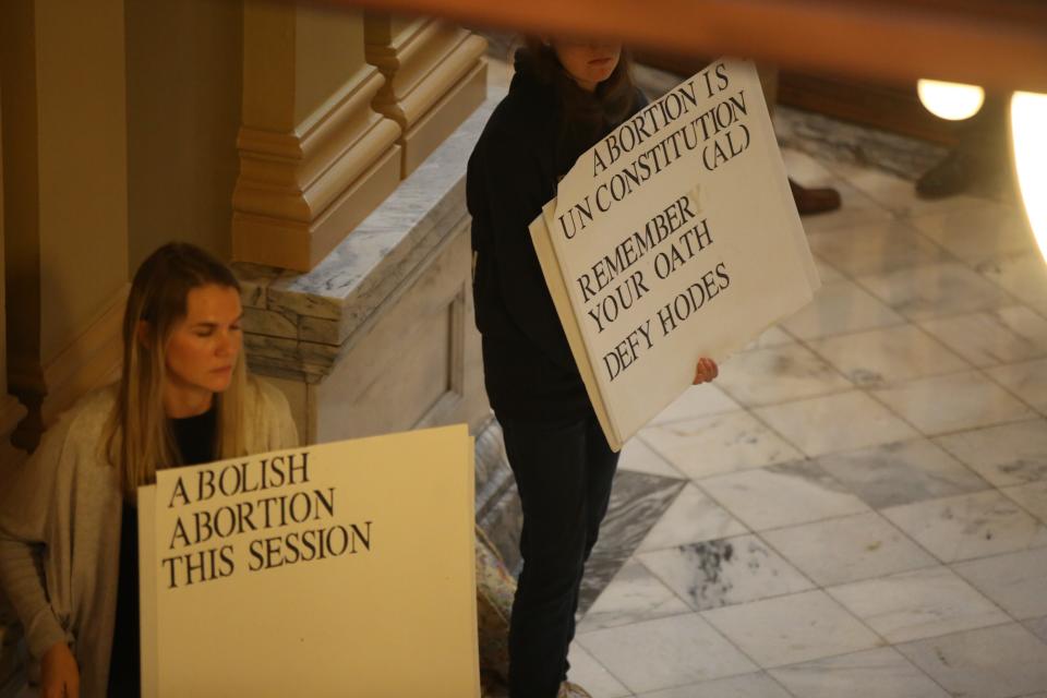 Anti-abortion signs greet lawmakers as they enter the House of Representatives for leadership elections on Dec. 5.
