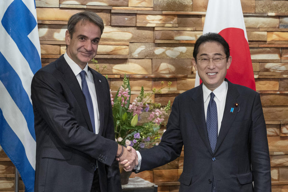 Greek Prime Minister Kyriakos Mitsotakis, left, is welcomed by Japanese Prime Minister Fumio Kishida upon his arrival ahead of their meeting at the prime minister's official residence in Tokyo on Monday, Jan. 30, 2023. (Richard A. Brooks/Pool Photo via AP)