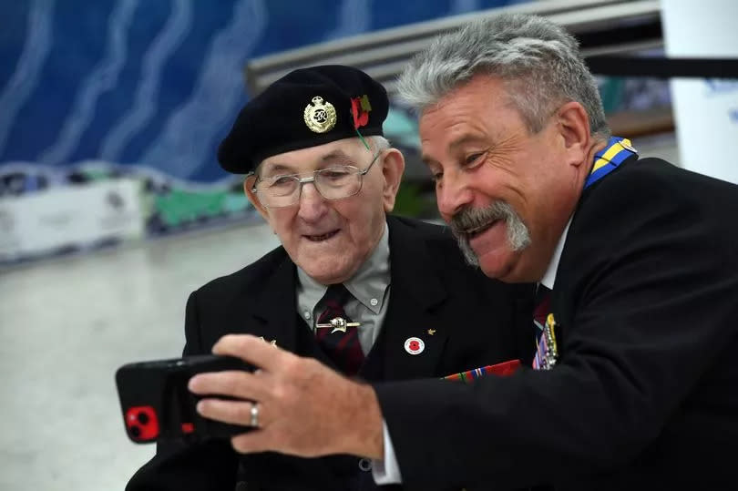 Cpl Pelzer smiles for a selfie with Phil Flowers MBE, known locally for the unwavering support he's given local veterans over the last 40 years