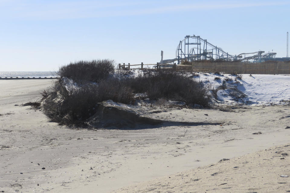 A severely eroded section of sand dune lines the beach in North Wildwood N.J., Jan. 22, 2024. A recent winter storm punched a hole through what is left of the city's eroded dune system, leaving it more vulnerable than ever to destructive flooding as the city and state fight in court over how best to protect the popular beach resort. (AP Photo/Wayne Parry)