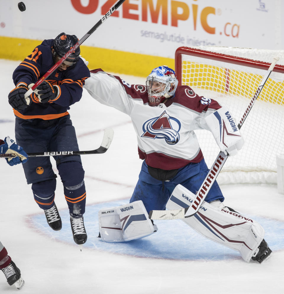 Colorado Avalanche goalie Pavel Francouz (39) reaches for the puck as Edmonton Oilers' Evander Kane (91) skates in front of the net during the second period of Game 3 of the NHL hockey Stanley Cup playoffs Western Conference finals Saturday, June 4, 2022, in Edmonton, Alberta. (Amber Bracken/The Canadian Press via AP)