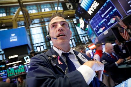 Traders work on the floor at the NYSE in New York