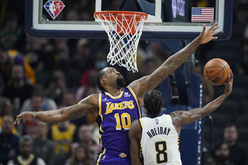 Indiana Pacers' Justin Holiday (8) shoots against Los Angeles Lakers' DeAndre Jordan (10) during the first half of an NBA basketball game Wednesday, Nov. 24, 2021, in Indianapolis. (AP Photo/Darron Cummings)