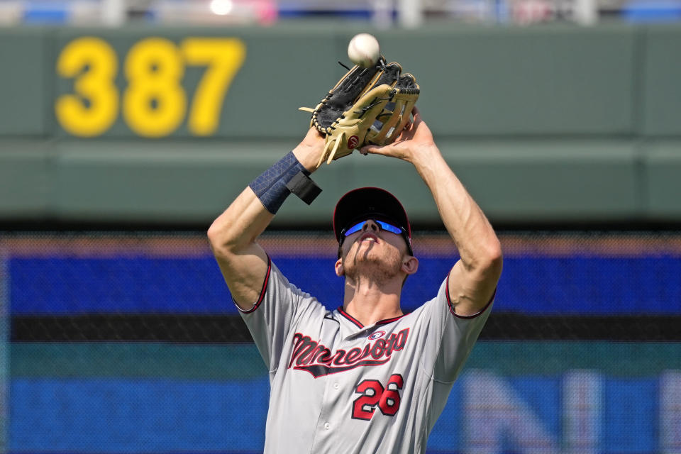 Minnesota Twins right fielder Max Kepler catches a fly ball for the out on Kansas City Royals' Carlos Santana during the ninth inning of a baseball game Sunday, July 4, 2021, in Kansas City, Mo. The Twins won 6-2. (AP Photo/Charlie Riedel)