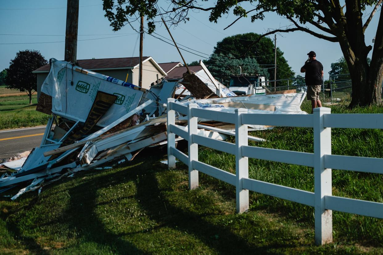 The driver of a semi-trailer that was hauling a mobile home talks on his cell phone after a crash at Ohio 93 and Barrs Mills Rd NW on Friday, June 21, in Sugarcreek Township. No injuries were reported.