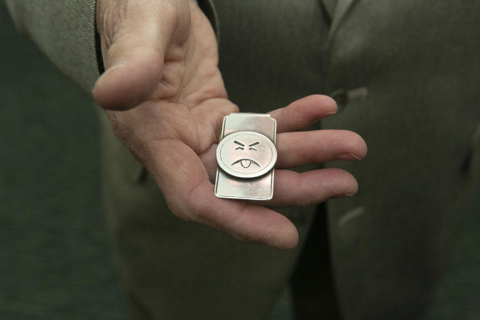 Dr. Richard Moriarty, creator of Mr. Yuk, shows his Mr. Yuk money clip, at Carnegie Museum of Natural History, Botany Hall, Thursday, June 1, 2023, in Oakland, Pa. Moriarty passed away on Thursday, Sept. 7, according to Jeffrey Fugh of the funeral home John A. Freyvogel Sons Inc., which is handling arrangements in Pittsburgh. (John Colombo /Pittsburgh Post-Gazette via AP)