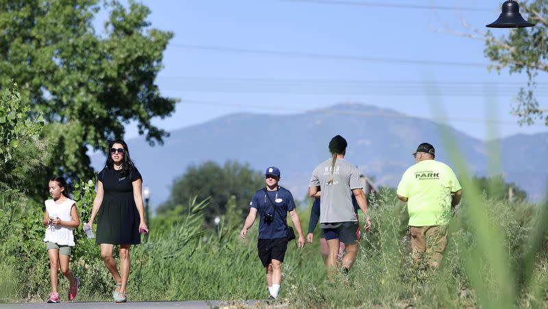 People walk in Pioneer Crossing Regional Park in West Valley on Thursday, July 20, 2023. Walking regularly can help improve your health, experts say.