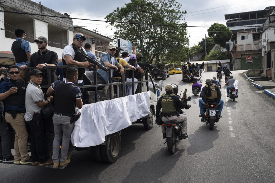 Soldiers guard near the vehicle used by presidential candidate Daniel Noboa, of the National Democratic Action Alliance political party, during a rally downtown in Esmeraldas, Ecuador, Friday, Oct. 6, 2023. Ecuador will hold a presidential runoff, Oct. 15. (AP Photo/Rodrigo Abd)