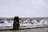 Demonstrators greet each other near the entrance of the Oceti Sakowin camp as "water protectors" continue demonstrations against plans to pass the Dakota Access pipeline continue near the Standing Rock Indian Reservation, near Cannon Ball, North Dakota, U.S., December 2, 2016. REUTERS/Lucas Jackson