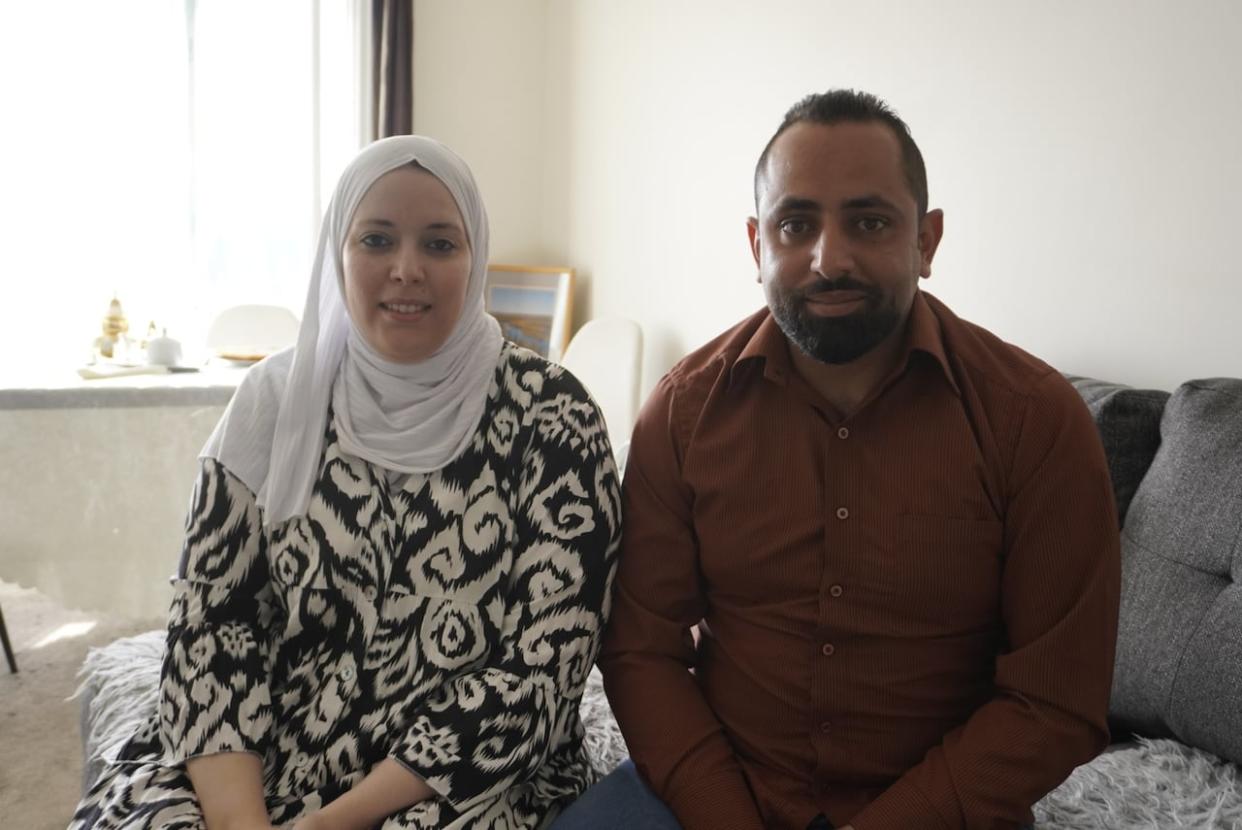 Yousef Alshayeb, who moved to Yellowknife last year, with his wife Houyame Elkhatri. Alshayeb wants to put to use his skills as medical tech in his new home city, but he can't get work in Canada without permanent residency. His application may take 2 years to process.  (Natalie Pressman/CBC - image credit)