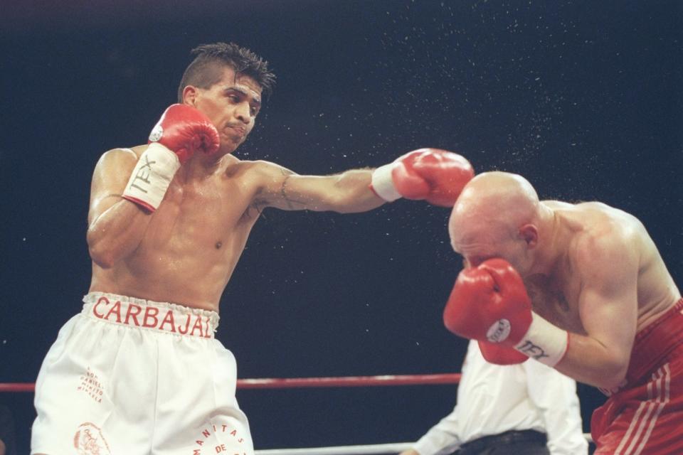 Michael Carbajal lands a punch to Scotty Olson's head during a fight at Memorial Coliseum in Corpus Christi, Texas, on March 22, 1997. Carbajal won the fight with a 10th-round knockout.