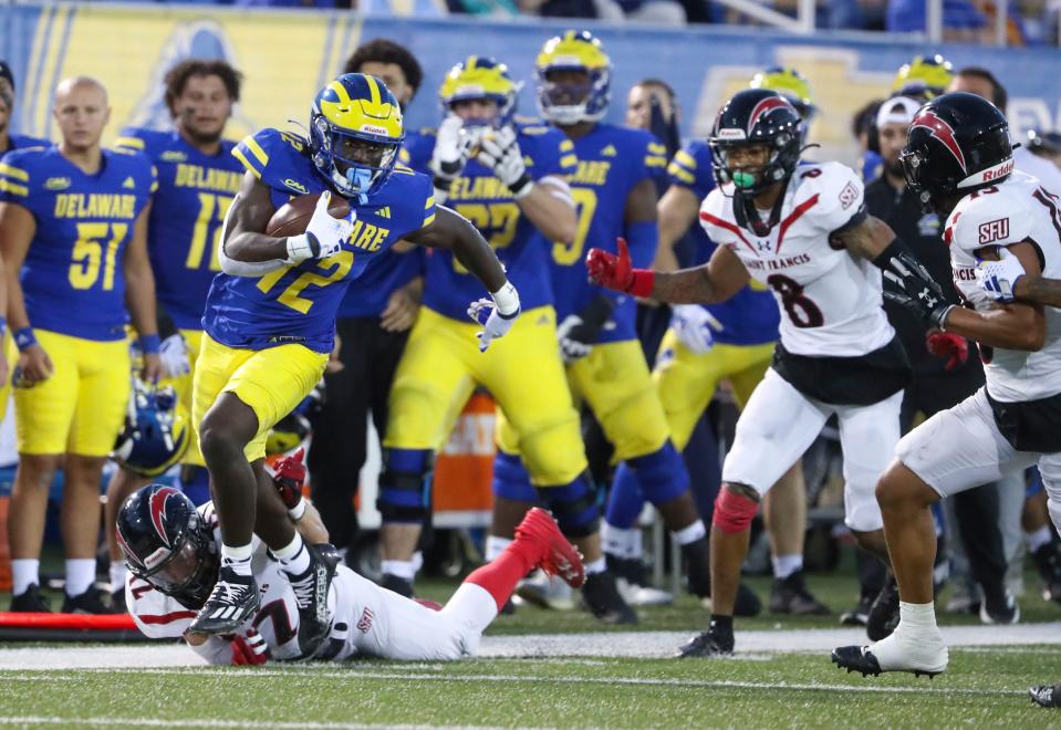 Delaware receiver Kym Wimberly leaves St. Francis defenders behind as he turns a reception into a touchdown in the final minute of the first half at Delaware Stadium, Saturday Sept. 16, 2023. The score gave the Hens a 21-7 lead going into the third quarter.