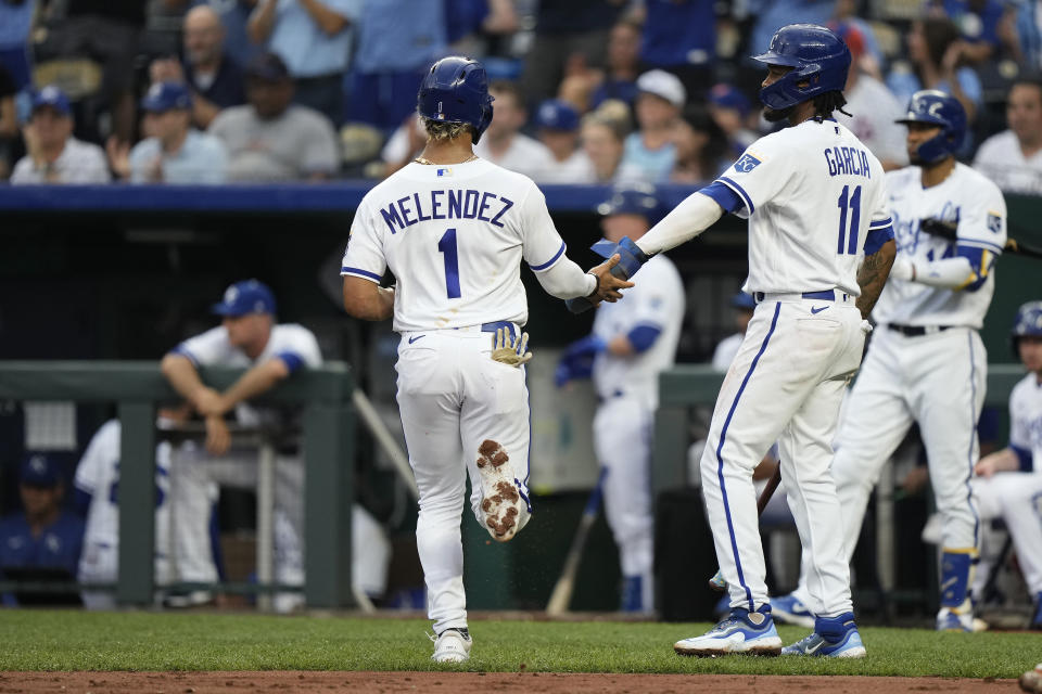 Kansas City Royals' MJ Melendez (1) and Maikel Garcia (11) celebrate after scoring on a two-run double hit by Michael Massey during the first inning of a baseball game against the New York Mets Wednesday, Aug. 2, 2023, in Kansas City, Mo. (AP Photo/Charlie Riedel)