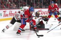 Mar 16, 2019; Montreal, Quebec, CAN; Montreal Canadiens center Michael Chaput (43) plays the puck against Chicago Blackhawks center Jonathan Toews (19) next to goaltender Corey Crawford (50) during the third period at Bell Centre. Mandatory Credit: Jean-Yves Ahern-USA TODAY Sports