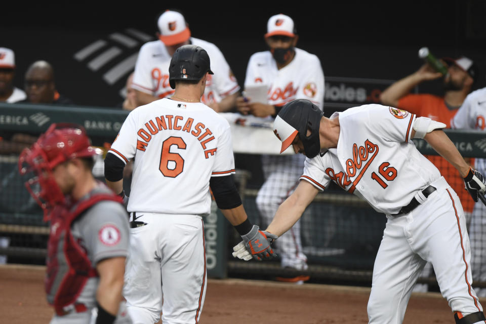 Baltimore Orioles' Ryan Mountcastle (6) is greeted by Baltimore Orioles' Trey Mancini (16) after hitting a solo home run against Los Angeles Angels starting pitcher Dylan Bundy during the first inning of a baseball game Tuesday, Aug. 24, 2021, in Baltimore. (AP Photo/Terrance Williams)