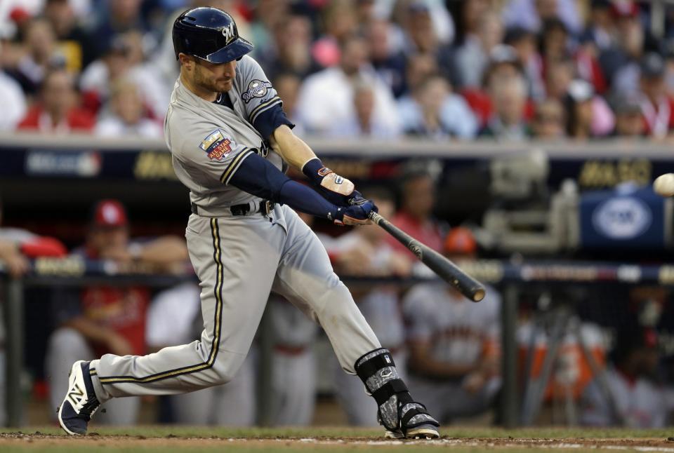 Jonathan Lucroy of the Milwaukee Brewers hits an RBI double during the second inning of the MLB All-Star baseball game, Tuesday, July 15, 2014, in Minneapolis.