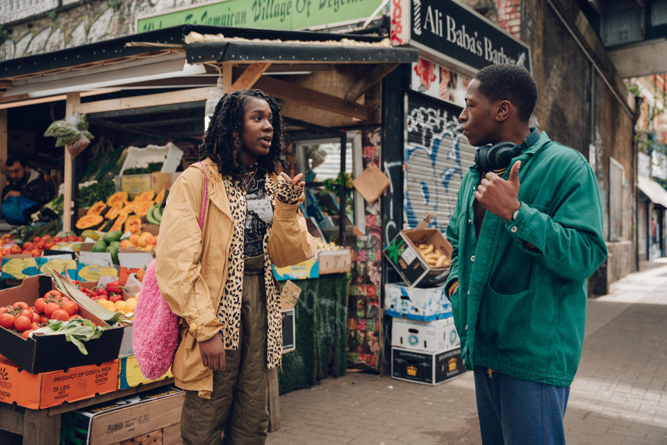 Yas (Vivian Oparah) and Dom (David Jonsson) stroll through the lively streets of Peckham.<span class="copyright">Chris Harris—Century Studios</span>