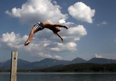 A man jumps into Lake Turnersee in the province of Carinthia, southern Austria, in this July 14, 2010 file photo. FILES REUTERS/Heinz-Peter Bader/Files