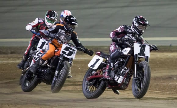 Indian Wrecking Crew member Bryan Smith racing on the track, with three other racers behind him.