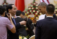 <p>U.S. President Barack Obam, right, and Vietnamese President Tran Dai Quang, toast during a State Luncheon at the International Convention Center in Hanoi, Vietnam, Monday, May 23, 2016. Obama on Monday lifted a half-century-old ban on selling arms to Vietnam during his first visit to the communist country, looking to bolster a government seen as a crucial, though flawed partner in a region he’s tried to place at the center of his foreign policy legacy. (AP Photo/Carolyn Kaster) </p>