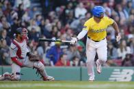 Boston Red Sox's Rafael Devers, right, runs after his two-run double in front of Washington Nationals catcher Keibert Ruiz, left, during the eighth inning of a baseball game, Saturday, May 11, 2024, in Boston. (AP Photo/Michael Dwyer)