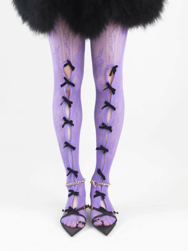 <p>Nodress Black Bowknot Purple Fishnet Stockings, $58, <a href="https://nodress67.com/collections/tights/products/shy045-black-bowknot-purple-fishnet-stockings" rel="nofollow noopener" target="_blank" data-ylk="slk:available here;elm:context_link;itc:0;sec:content-canvas" class="link ">available here</a> (One Size)</p>