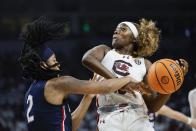 South Carolina guard Raven Johnson, right, drives into UConn guard KK Arnold during the first half of an NCAA college basketball game in Columbia, S.C., Sunday, Feb. 11, 2024. (AP Photo/Nell Redmond)