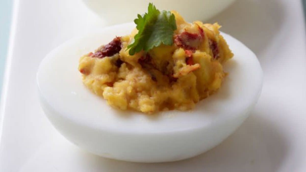 <p>Con Poulos</p><p>Chipotle chiles and fresh cilantro give the filling in these deviled eggs a flavorful kick.</p><p><strong>Get the recipe: <a href="https://parade.com/28482/epicurious/chipotle-deviled-eggs/" rel="nofollow noopener" target="_blank" data-ylk="slk:Chipotle Deviled Eggs;elm:context_link;itc:0;sec:content-canvas" class="link rapid-noclick-resp">Chipotle Deviled Eggs</a></strong></p>