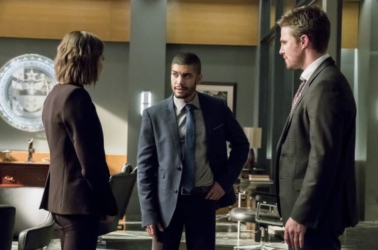 Willa Holland as Thea Queen, Rick Gonzalez as Rene Ramirez, and Stephen Amell as Oliver (Credit: Photo: Katie Yu/The CW)
