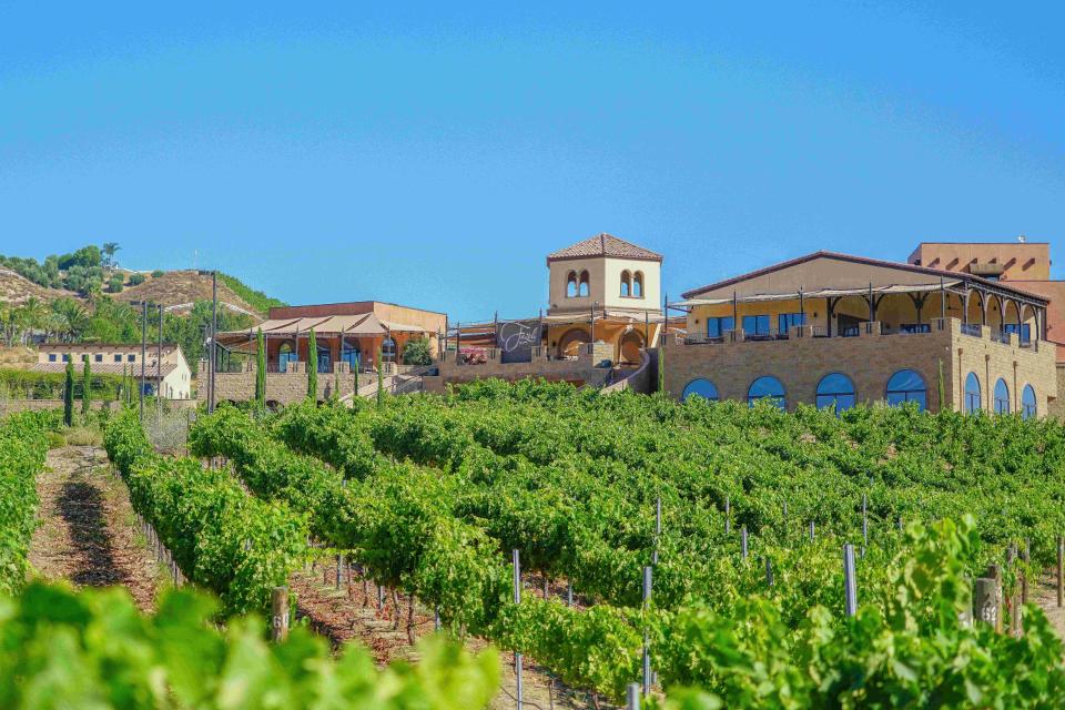 The Fazeli Cellars main building above its green vineyards in Temecula, California