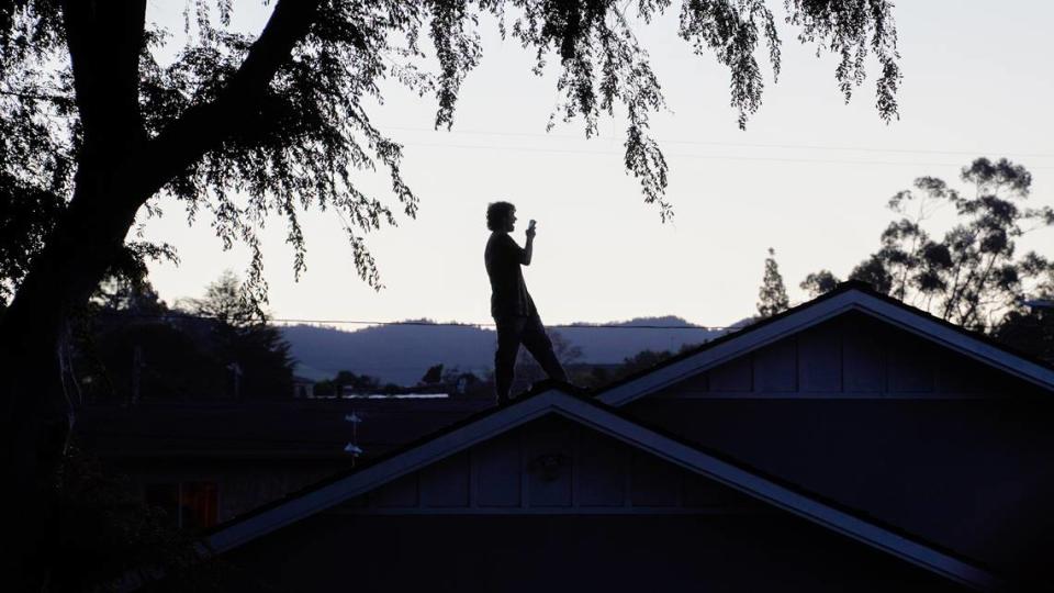A party-goer stands on a rooftop on Hathway Avenue near Cal Poly during St. Fratty’s Day festivities on March 16, 2024. A San Luis Obispo Police Department officer at the scene of the party estimated between 6,000 and 7,000 people in attendance.