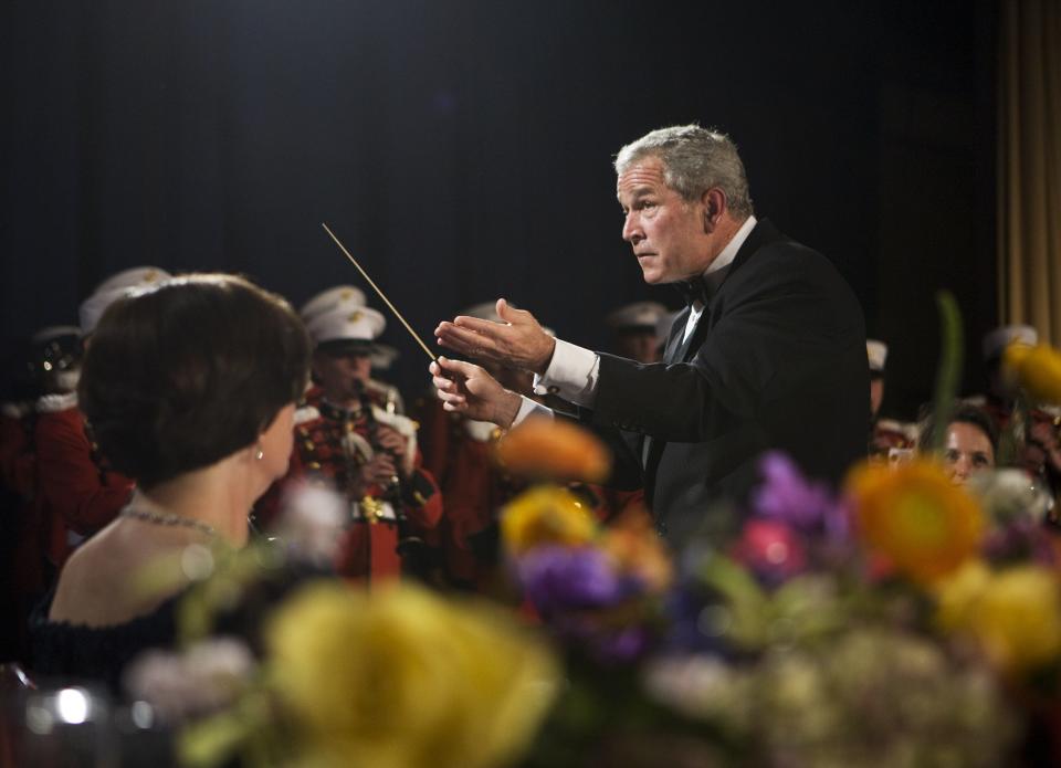 President George W. Bush conducts the U.S. Marine Band at the White House Correspondents' Association dinner on April 26, 2008, in Washington, D.C.