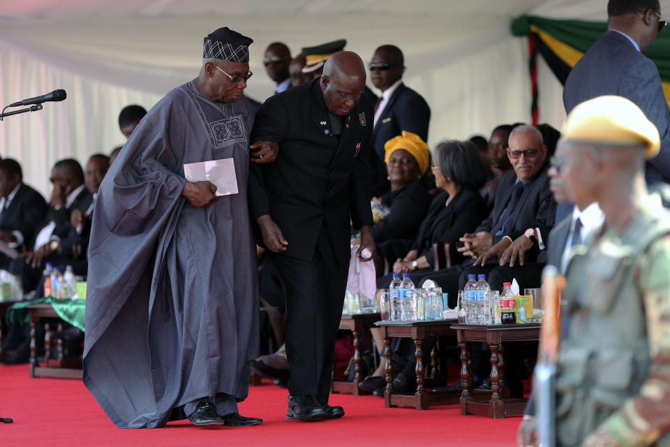 FILE - In this Saturday Sept. 14, 2019 file photo, former Zambia President Kenneth Kaunda is supported by former Nigerian President Olusegan Obasanjo, left, at the state funeral of former Zimbabwean leader, Robert Mugabe in Harare, Zimbabwe. Zambia’s first president Kenneth Kaunda has died at the age of 97, the country's president Edward Lungu announced Thursday June 17, 2021. (AP Photo/Tsvangirayi Mukwazhi, File)